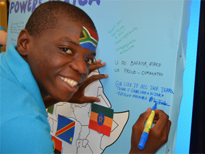Samsung Youth Reporter, Refiloe Machaba, writing a message of support on the Samsung campaign board.