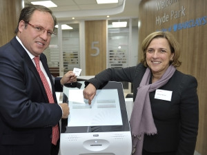 Barclays Africa and Absa's Head of Personal and Business Banking, Craig Bond, and Maria Ramos, Group Chief Executive of Absa, standing in front of the Qmatic Intro 17, at the Absa Hyde Park unveiling this month, Johannesburg. Photo: Media24 / Photo24.