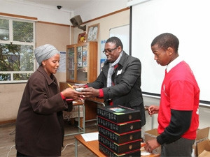 A teacher receives one of the 216 tablets that were distributed to rural schools as part of the TECH4RED initiative.