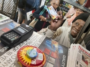 Grace Nhlapo, a cardholder who can now use her card to purchase groceries at a merchant because of the newly equipped technology.