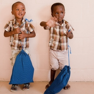 Twin boys receiving bags of stationery, March 2013.