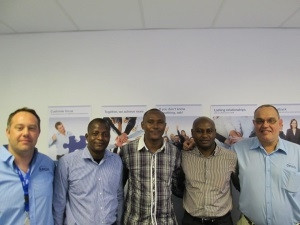 A photograph of the Nigerian Sejeh POS team at an Arch training session in Cape Town.  F.l.t.r: Reuben Kloot (Arch), Yemi Odesanmi, Olawale Fatokun, Samuel Ejeh and David Geldenhuys (Arch)