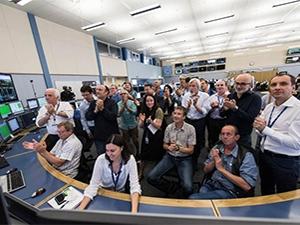 Scientists celebrate the kick-off of the second run of the Large Hadron Collider.