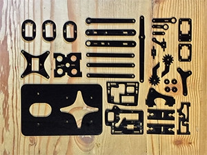 The laser cut parts that make up the eeArm robot kit.