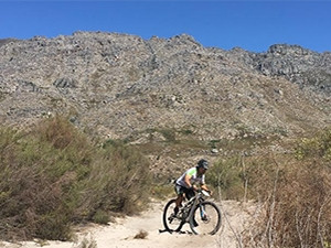 JP d'Abbadie wades through thick sand banks at the top of a mountain during the Absa Cape Epic.