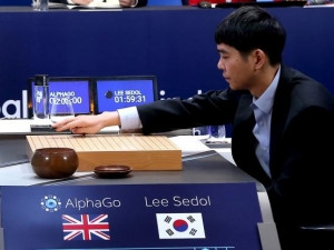 Go world champion Lee Sedol places the first piece against Google's artificial intelligence program AphaGo.
