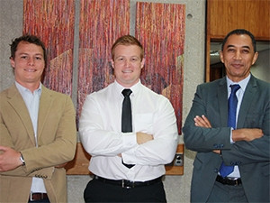 Happimo CEO Craig Rivett (left) and NMMU vice-chancellor professor Derrick Swartz (right) congratulate Martin Smuts.
