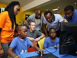 Facebook CEO Mark Zuckerberg interacts with children participating in the summer of coding camp at the Co-creation Hub in Nigeria.