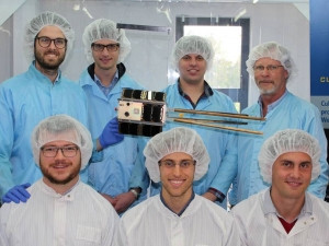 The QB50 team, from left to right at the front, Gerhard Janse van Vuuren, Jako Gerber and Douw Steyn, in the centre, ZA-AeroSat and, from left to right at the back, Mike-Alec Kearney, Willem Jordaan, Christo Groenewald and professor Herman Steyn.