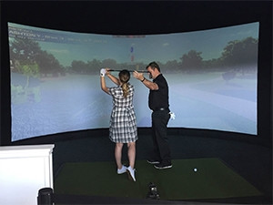 Amateur players could practice their swing, hitting into a simulation screen powered by About Golf.