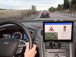 Ford tests technology in some of its cars that will gather information from roadside units and recommend speeds to help drivers make every green light.