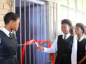 Students from Masiphathisane Secondary School cut the ribbon to their new functioning bathrooms.