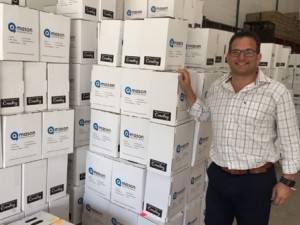 Mr. Dave Boulle, Managing Director of Mason Complete Office Solutions (Pty) Ltd with a batch of stationery to be delivered to subscribers of the "Mason Back to School" programme.