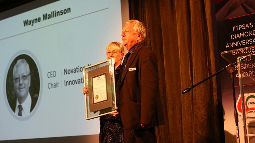 Wayne Mallinson receiving the IITPSA Fellowship Award from Moira de Roche.