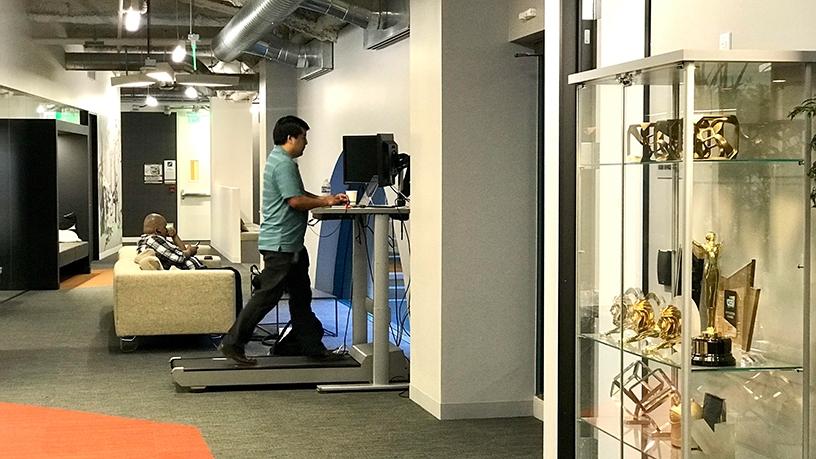 A desk connected to a treadmill.