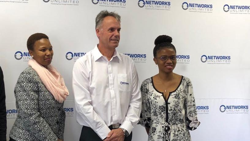 Networks Unlimited MD Anton Jacobsz with The Love Trust's Abigail Khuluse and Hlengiwe Shakung.