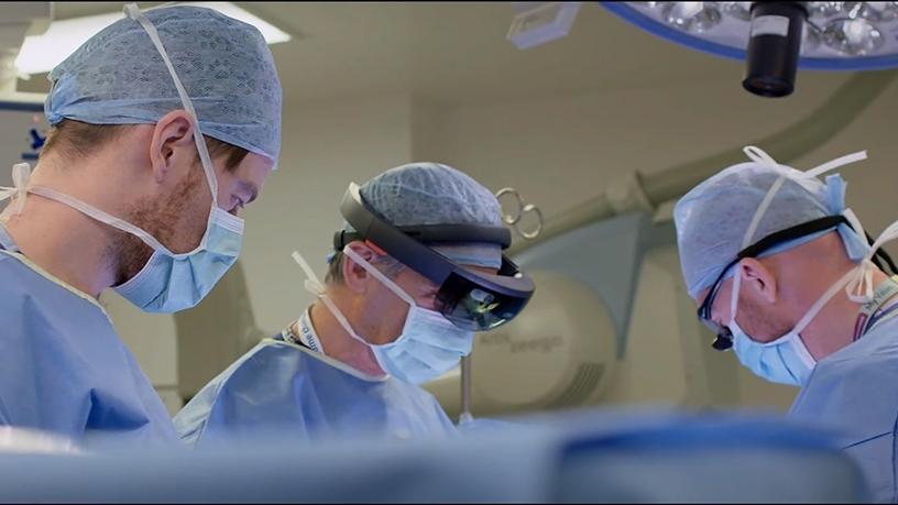 A doctor using the Microsoft HoloLens while performing surgery.